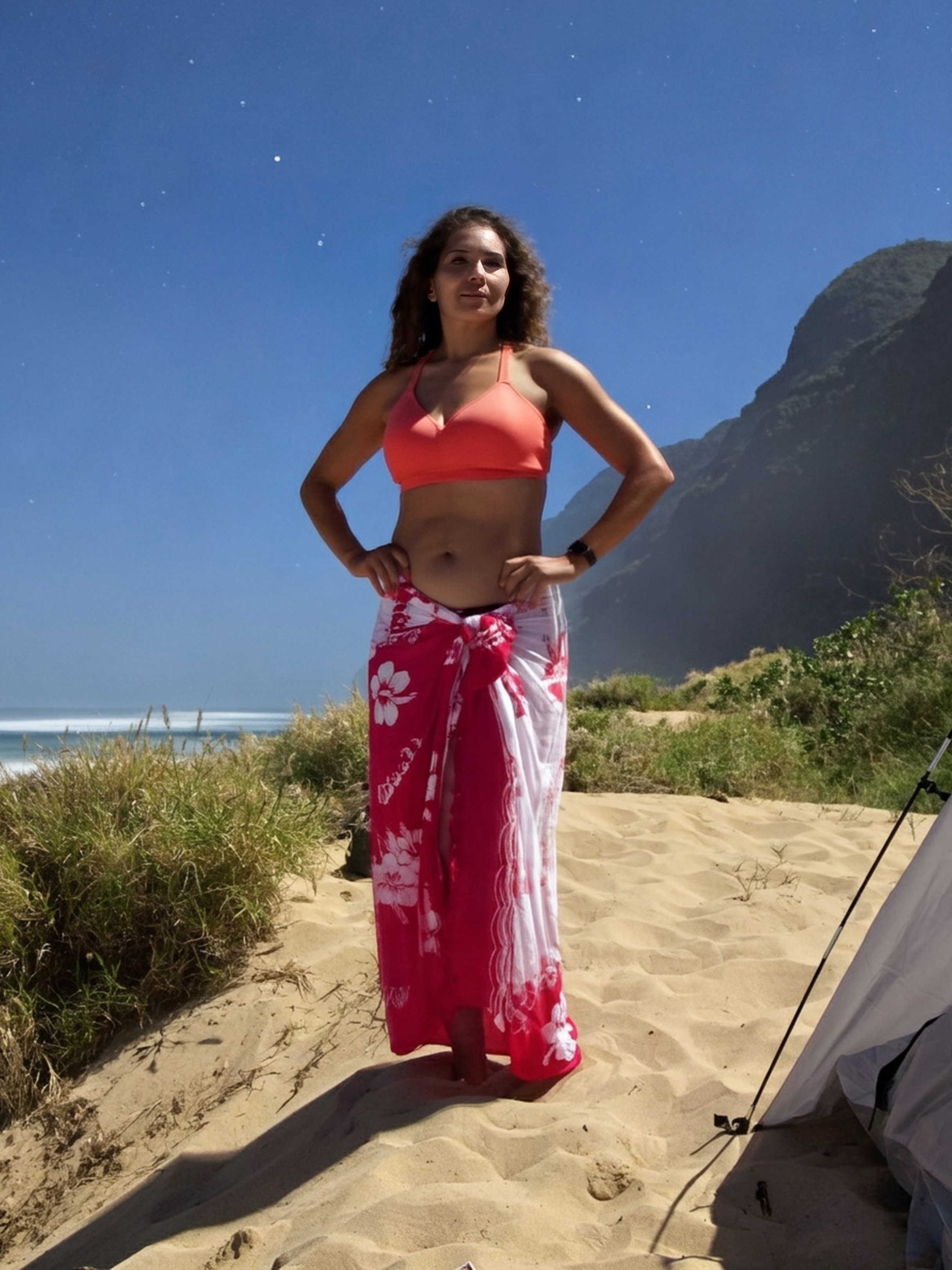 Portrait in a vivid red dress contrasting with the NaPali landscape